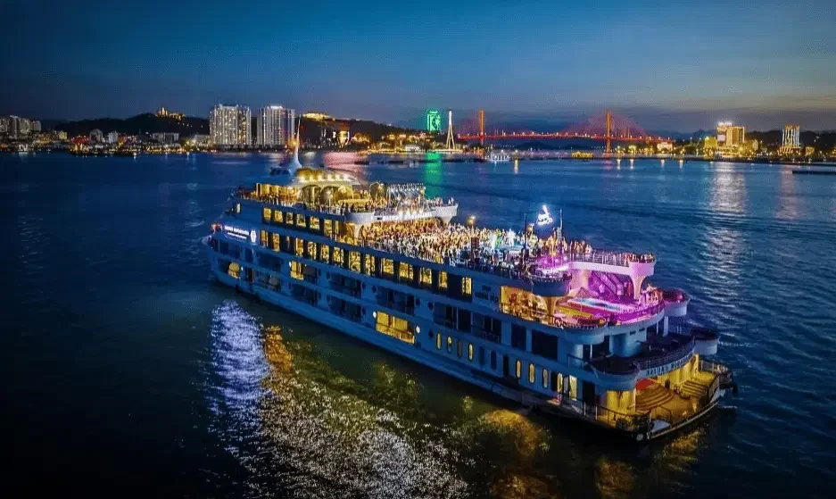 Best Dinner Cruise in Goa sailing at night with vibrant city lights and festive atmosphere — Goa Tourist Taxi