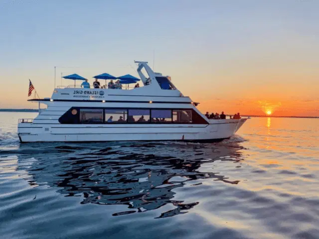 Luxury yacht with guests enjoying the best sunset cruise in Goa by Goa Tourist Taxi